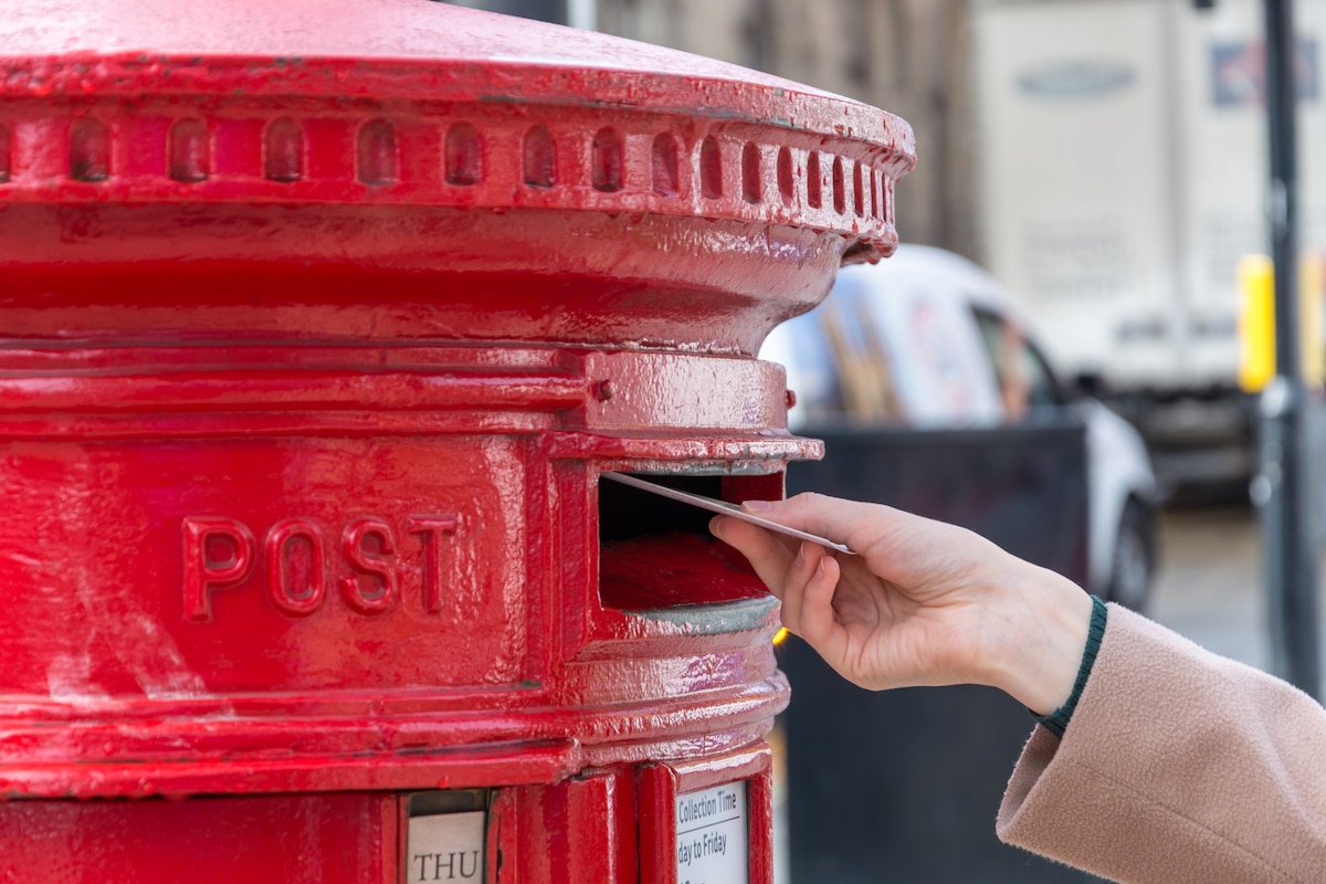close-up-hand-holding-red-mailbox.jpg